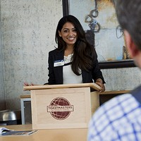 Woman giving a presentation behind a lectern